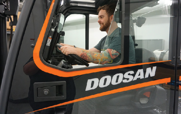Forklift Operator Driving Doosan Forklift